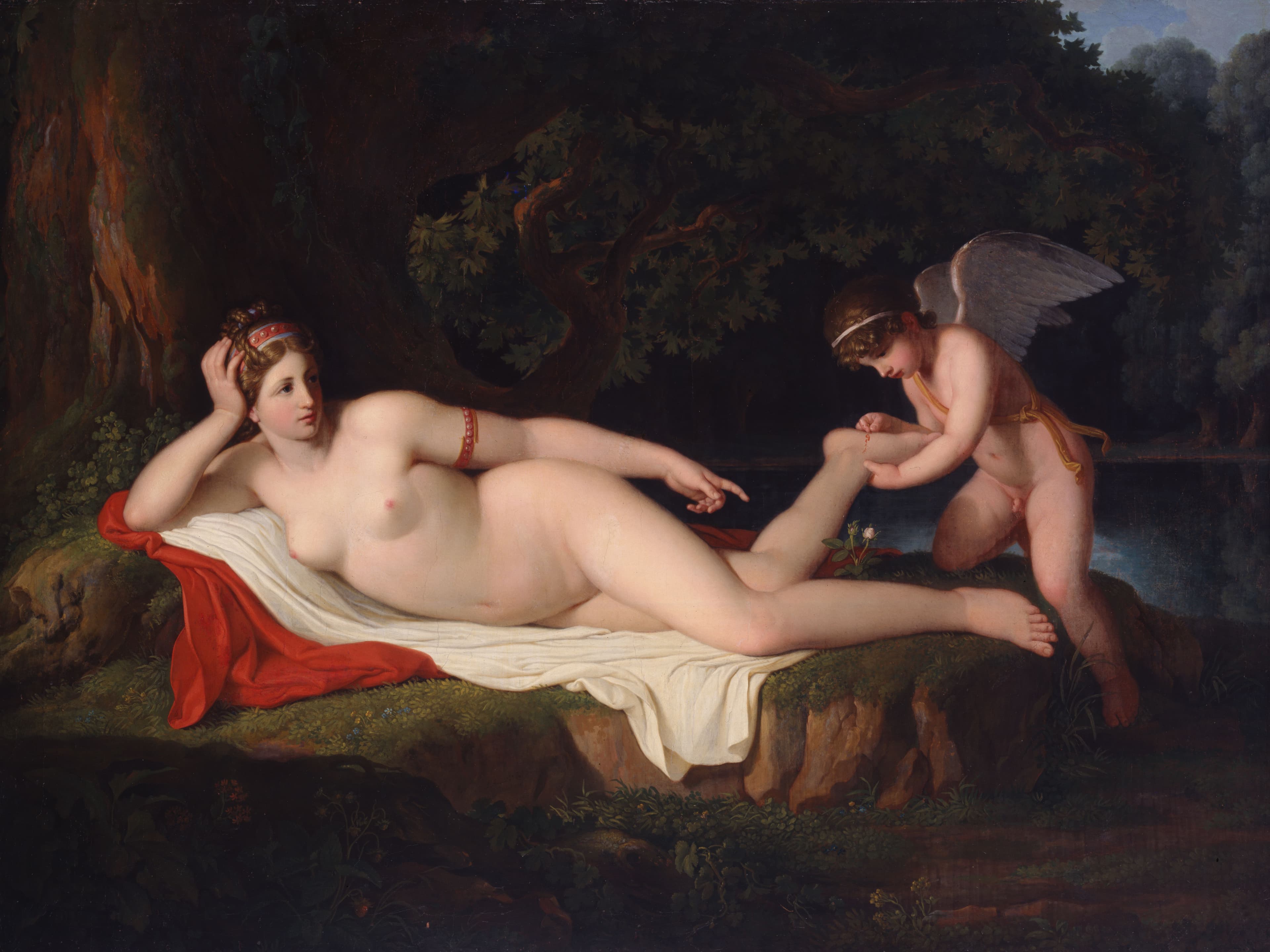 Painting showing a small winged naked boy who appears to be pulling a thorn out of the foot of a reclining naked woman.