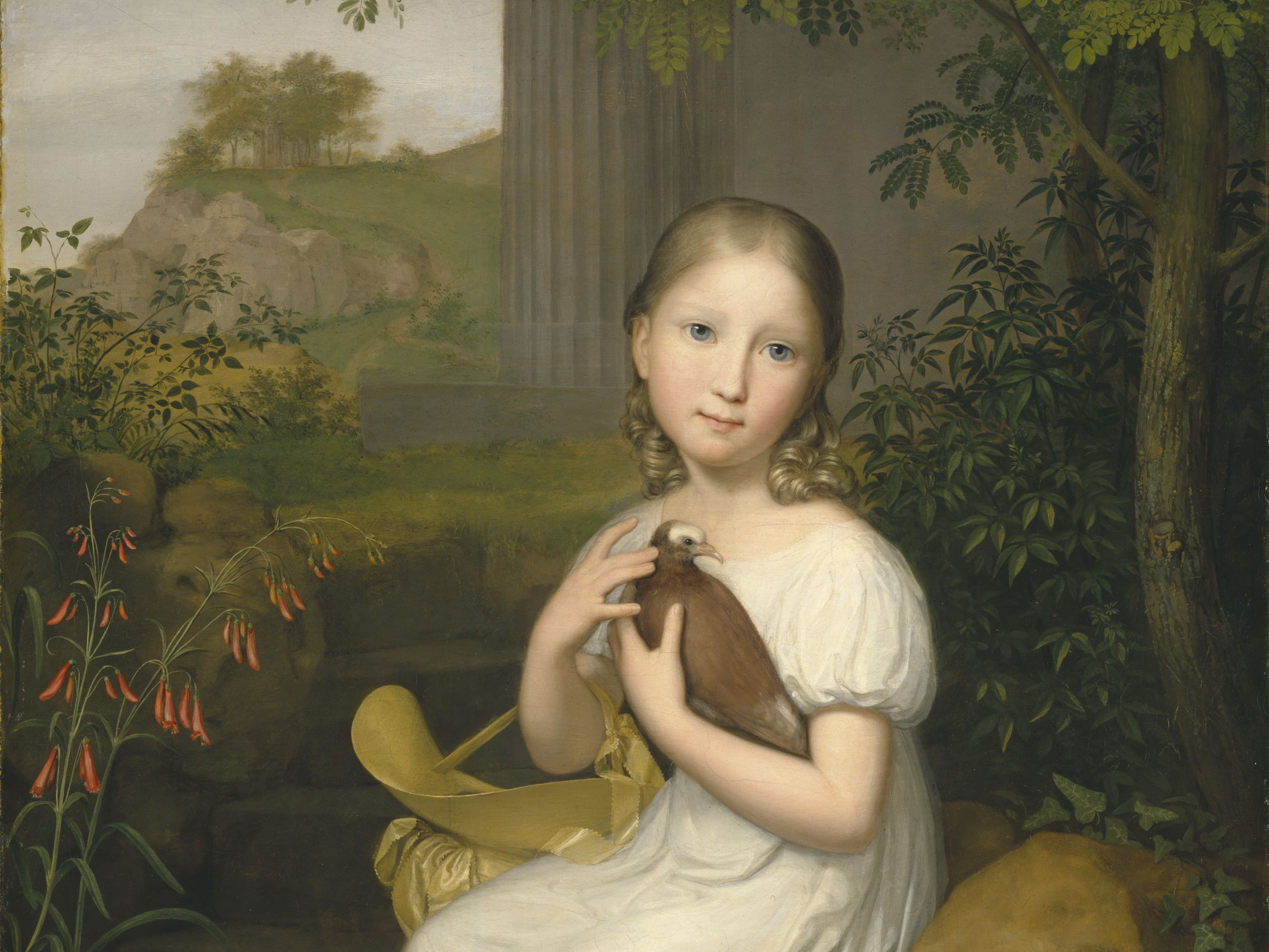 A young girl in a white dress sits on a stone, holding a small brown bird, surrounded by lush greenery and flowers.